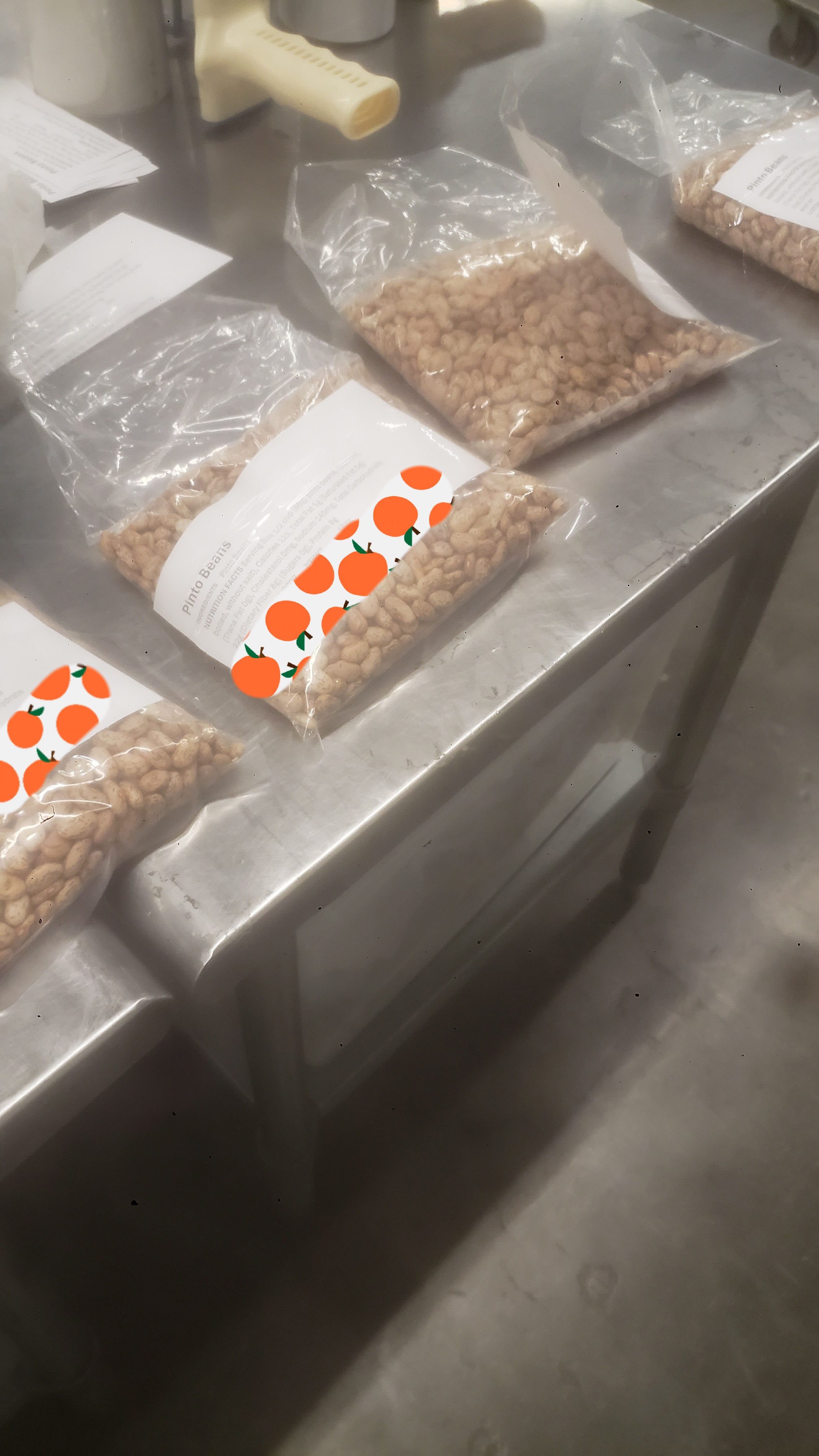 Bags of pinto beans with labels.